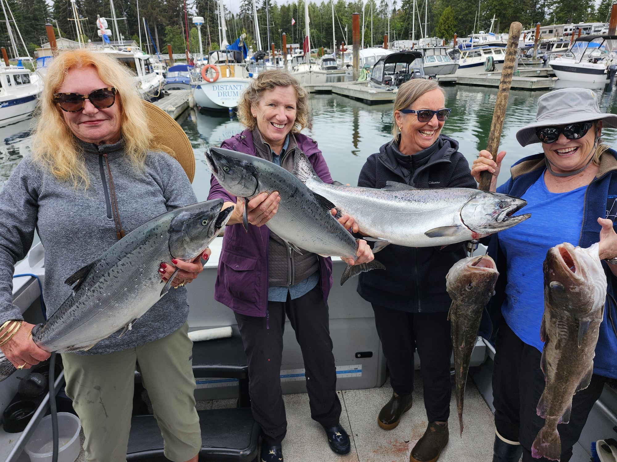 A group of women show the catches of the day