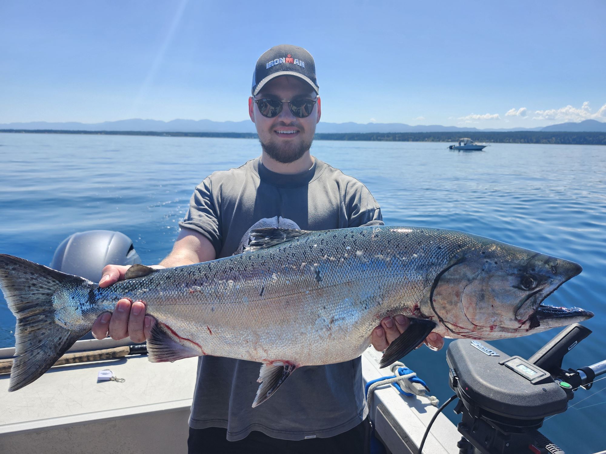 A man poses with a very large salmon