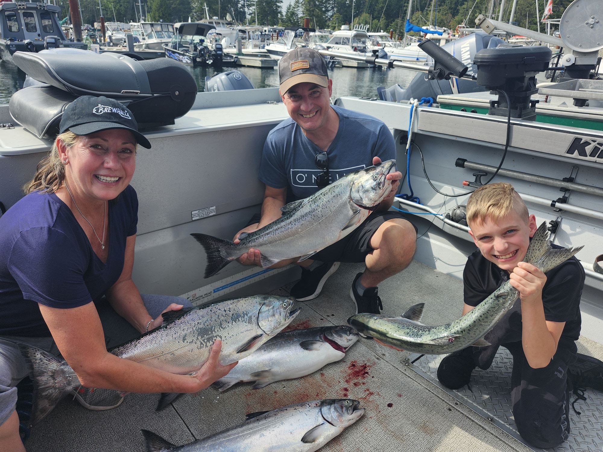 A family shows off the many fish they caught.