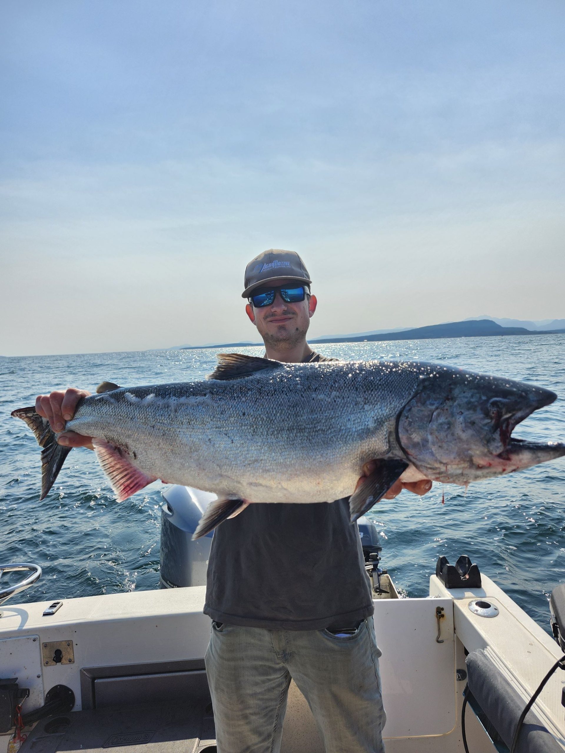 A man poses with a giant salmon