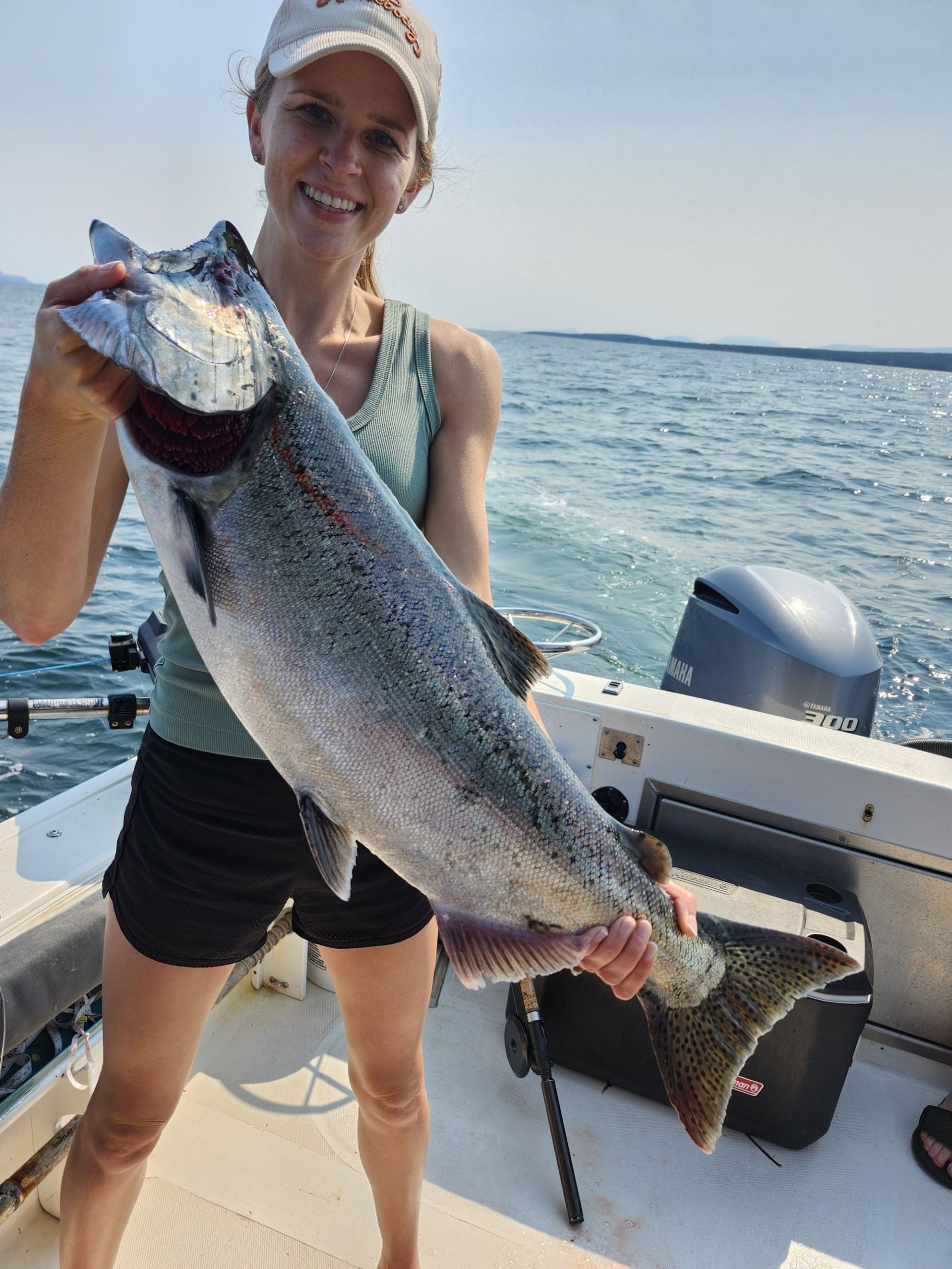 A woman poses with her large salmon