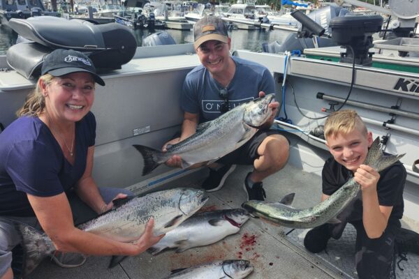 SLABRADOR-SALMON-CHARTERS-Gallery1 A family smiles at the results of their fishing trip